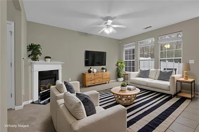 a living room with furniture a fireplace and a flat screen tv