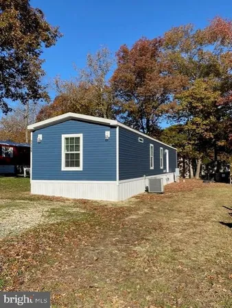 a house that has a tree in front of it