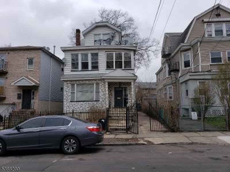 a front view of a house with parking space