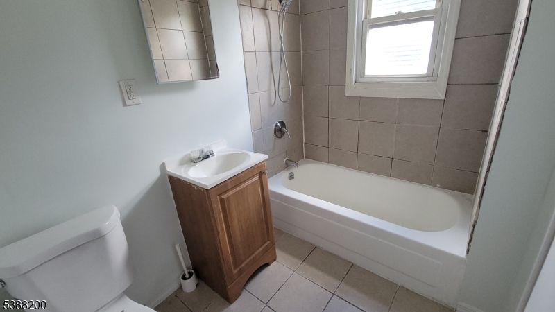 69 Mapes Avenue Newark, NJ 07112 - Photo 7 of 7 a bathroom with a tub a sink and a toilet