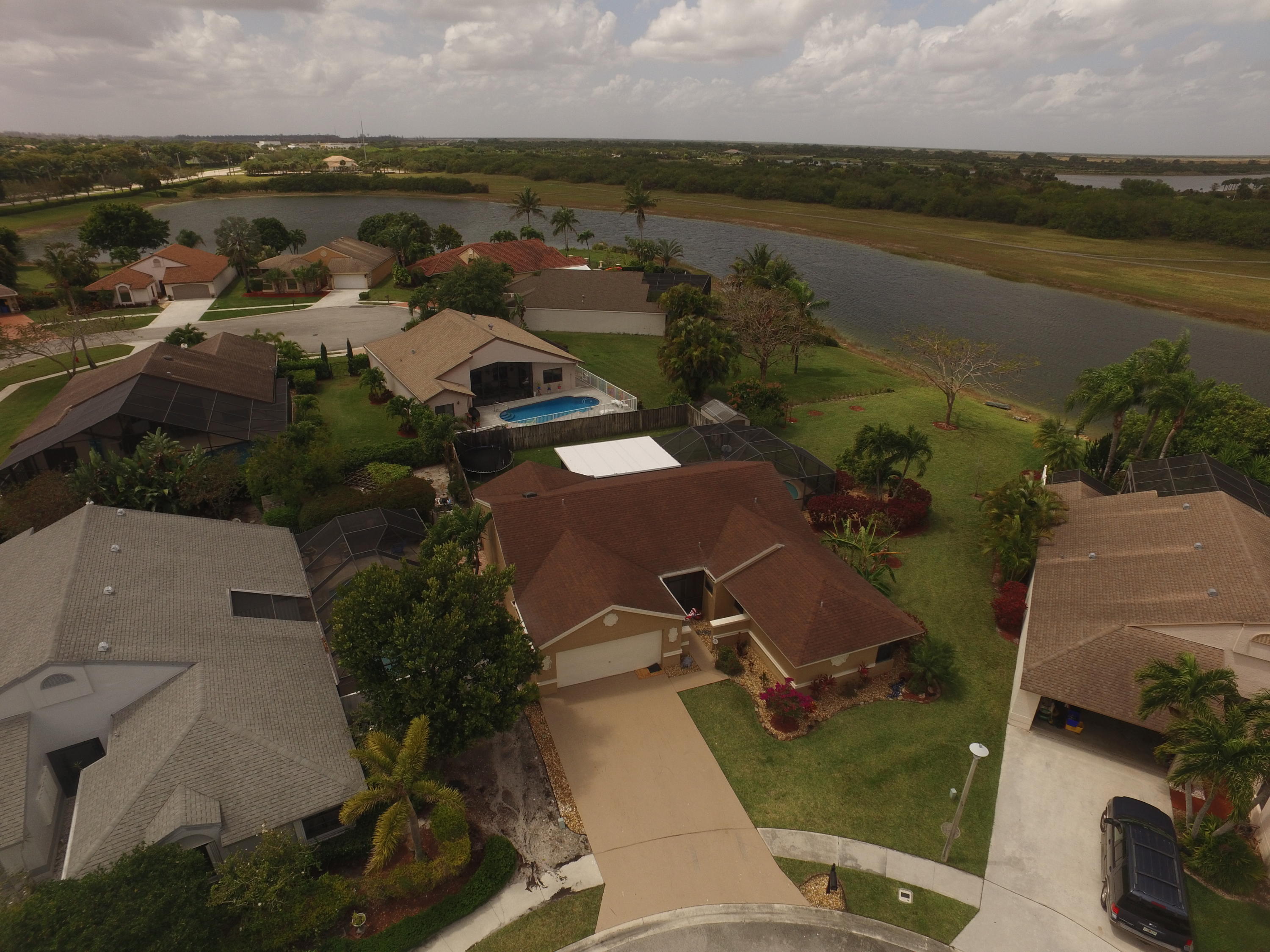 an aerial view of ocean with residential house with outdoor space and seating