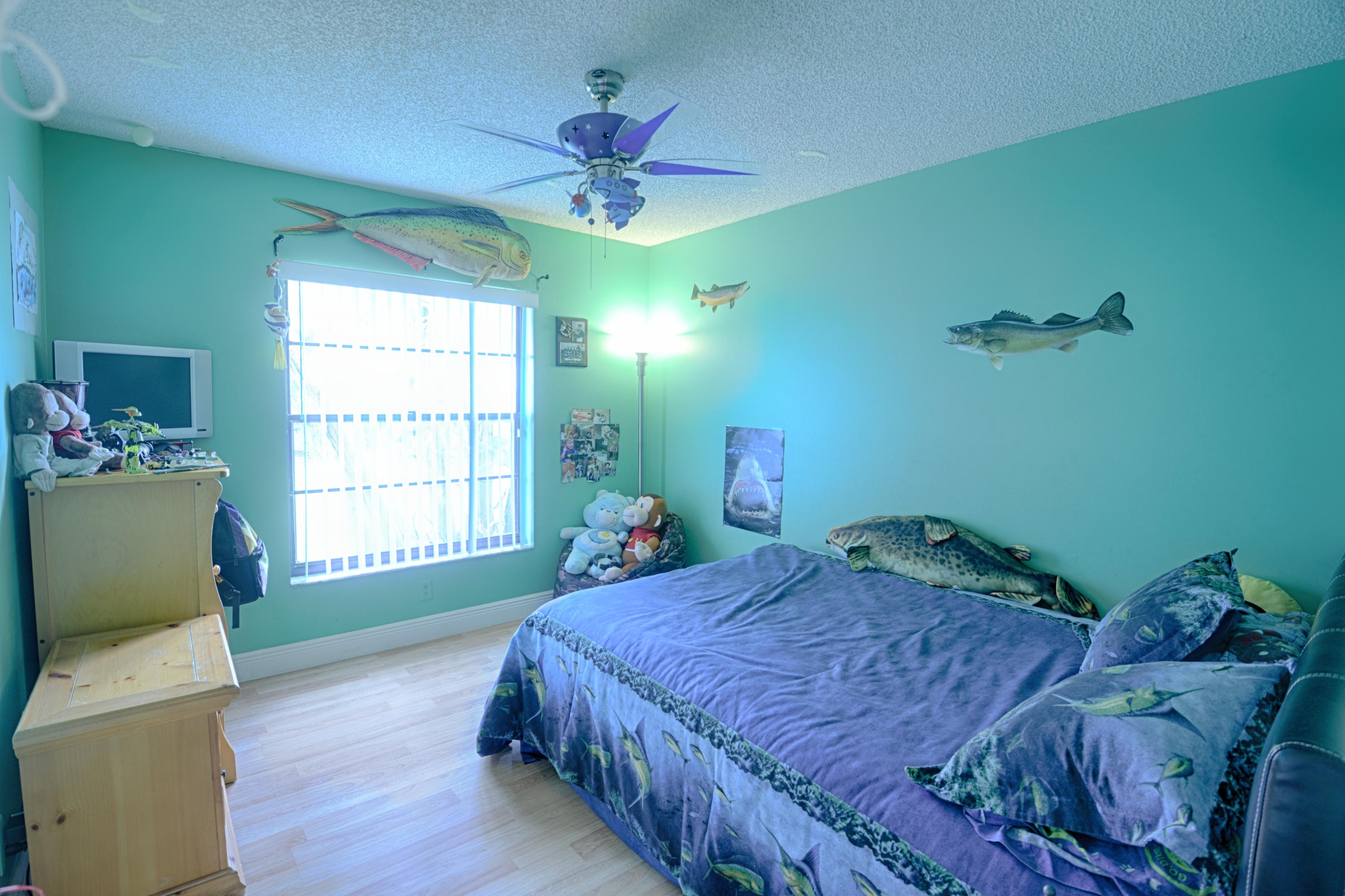 11885 Sunchase Court Boca Raton, FL 33498 - Photo 13 of 25 a bedroom with a bed and a chandelier