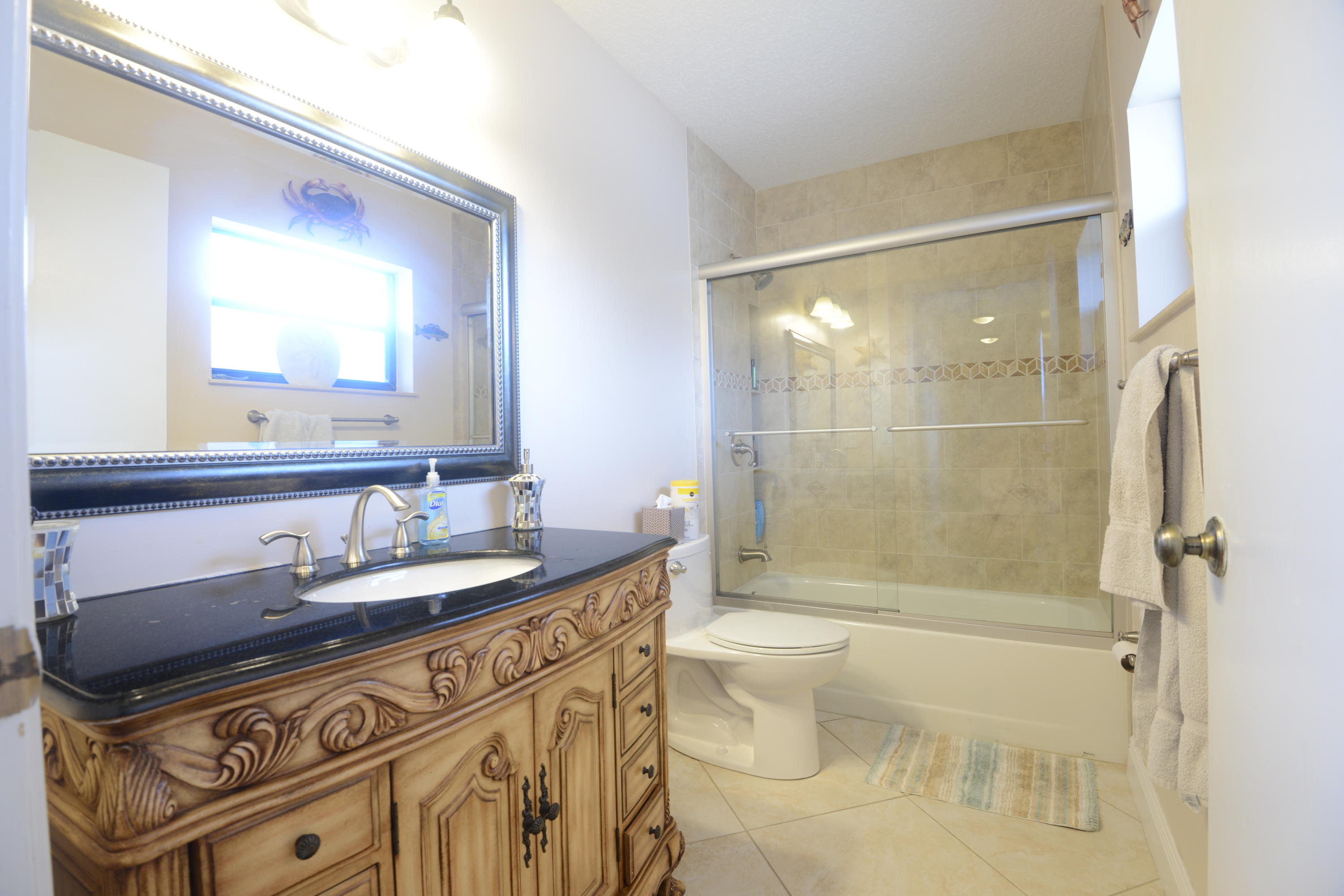 11885 Sunchase Court Boca Raton, FL 33498 - Photo 14 of 25 a bathroom with a sink a toilet and shower