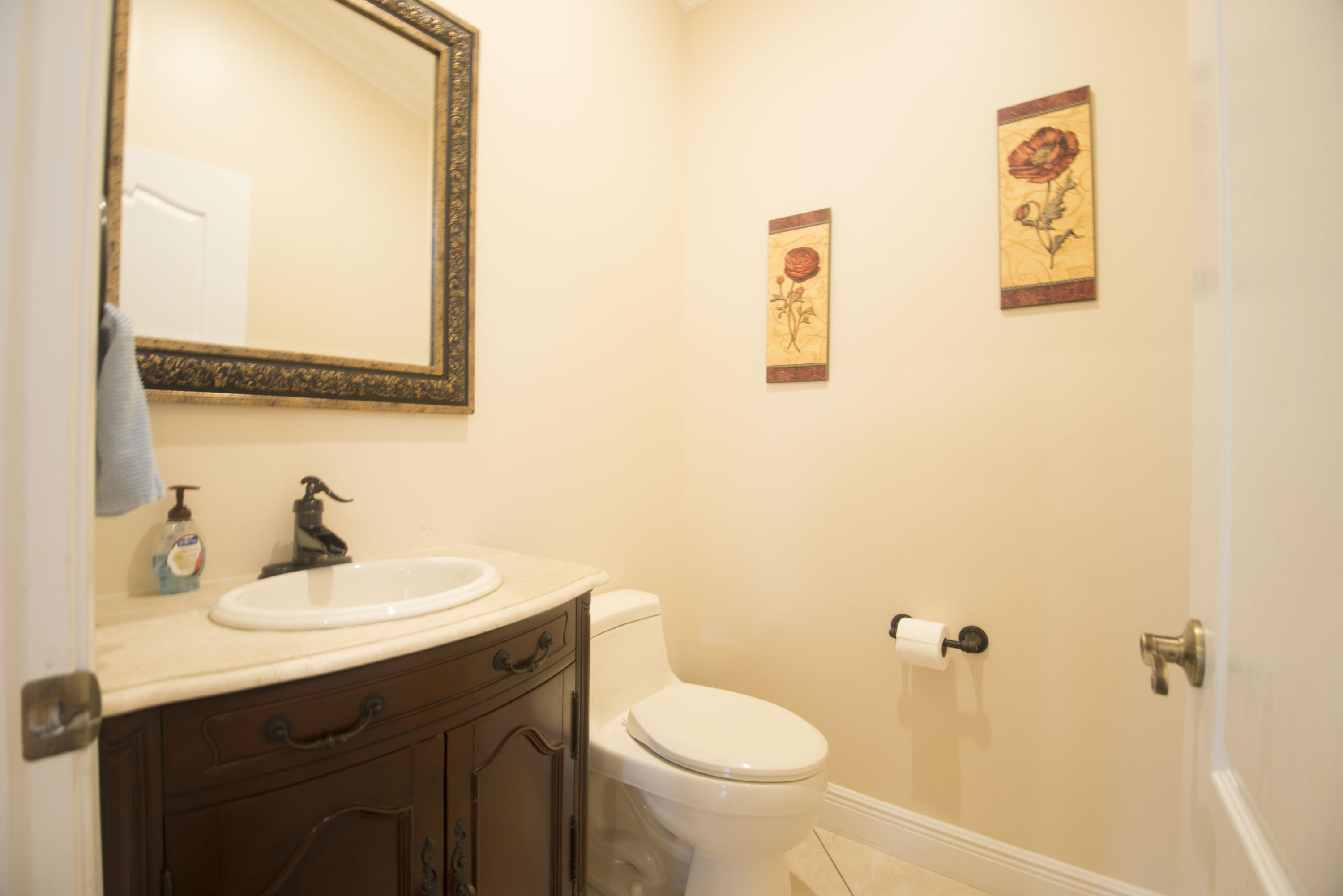 11885 Sunchase Court Boca Raton, FL 33498 - Photo 15 of 25 a bathroom with a sink and a mirror