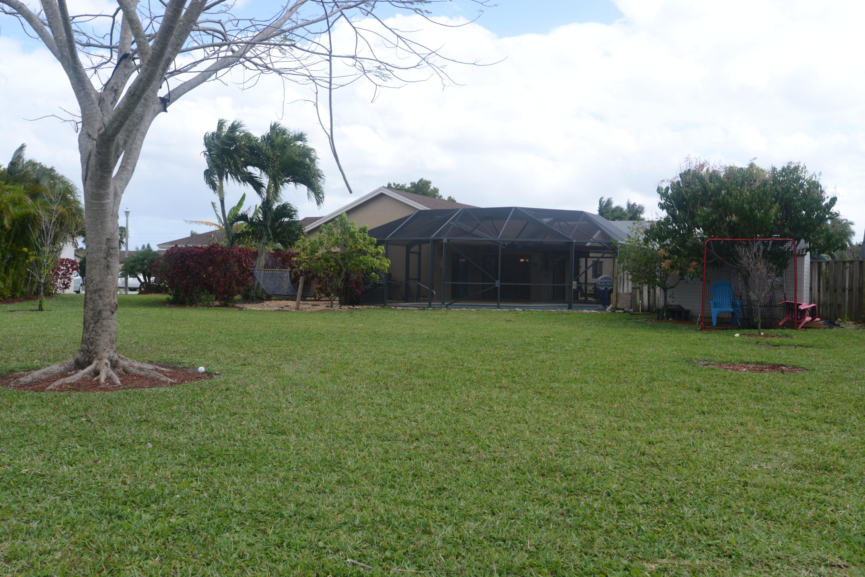 11885 Sunchase Court Boca Raton, FL 33498 - Photo 18 of 25 a view of a garden with a house