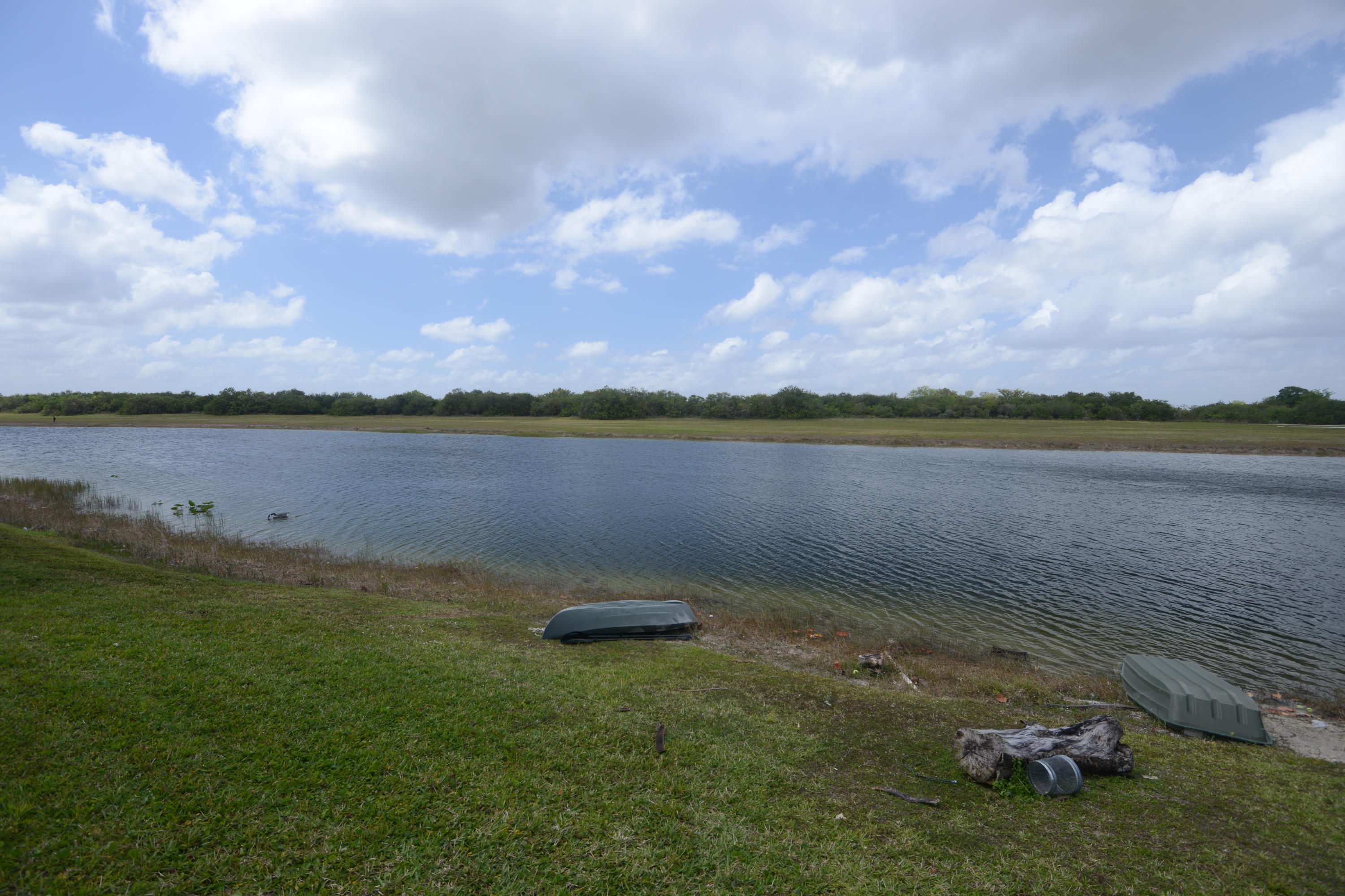 11885 Sunchase Court Boca Raton, FL 33498 - Photo 22 of 25 a view of a lake with houses in the background