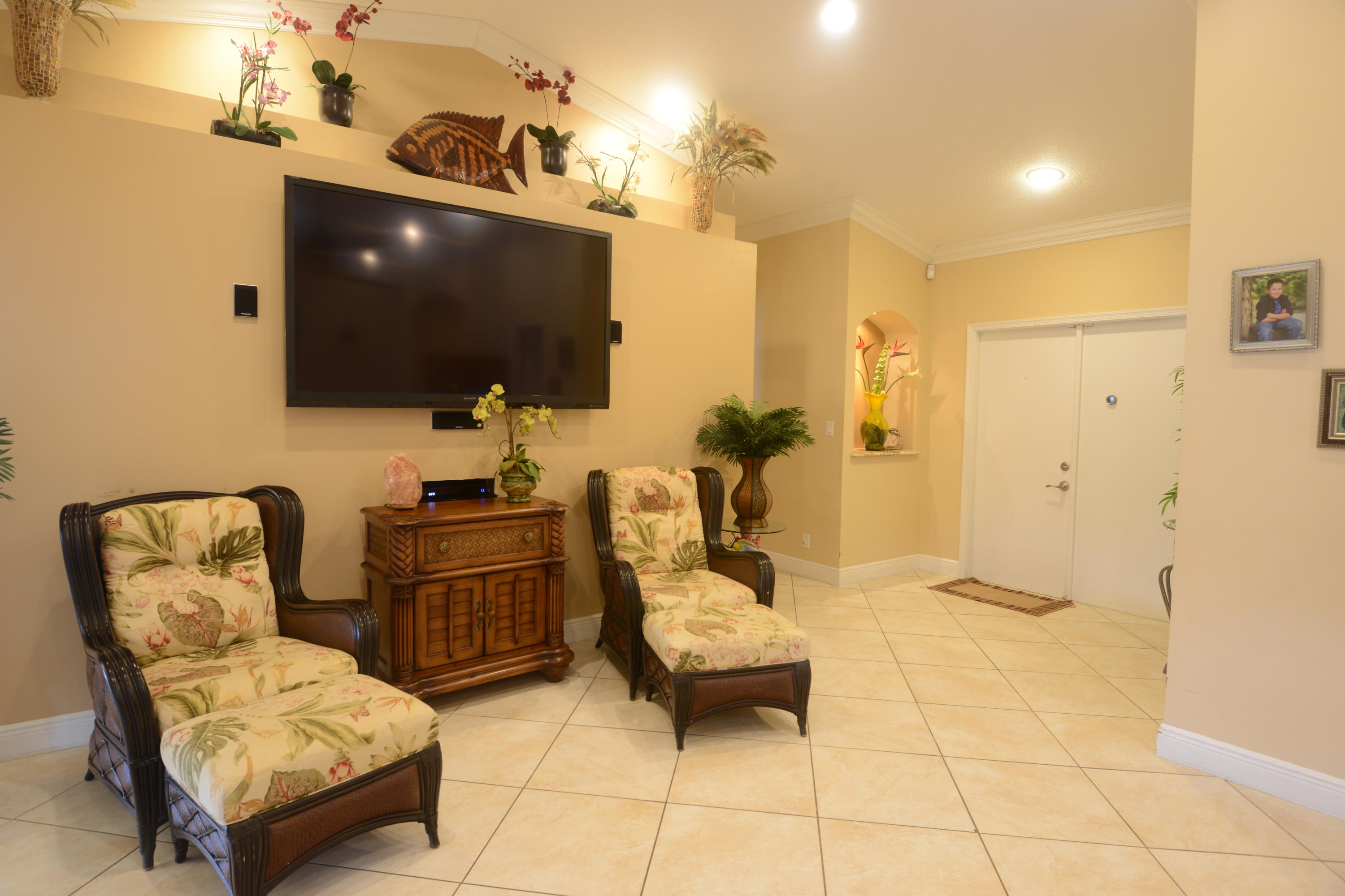 11885 Sunchase Court Boca Raton, FL 33498 - Photo 3 of 25 a living room with furniture and a flat screen tv