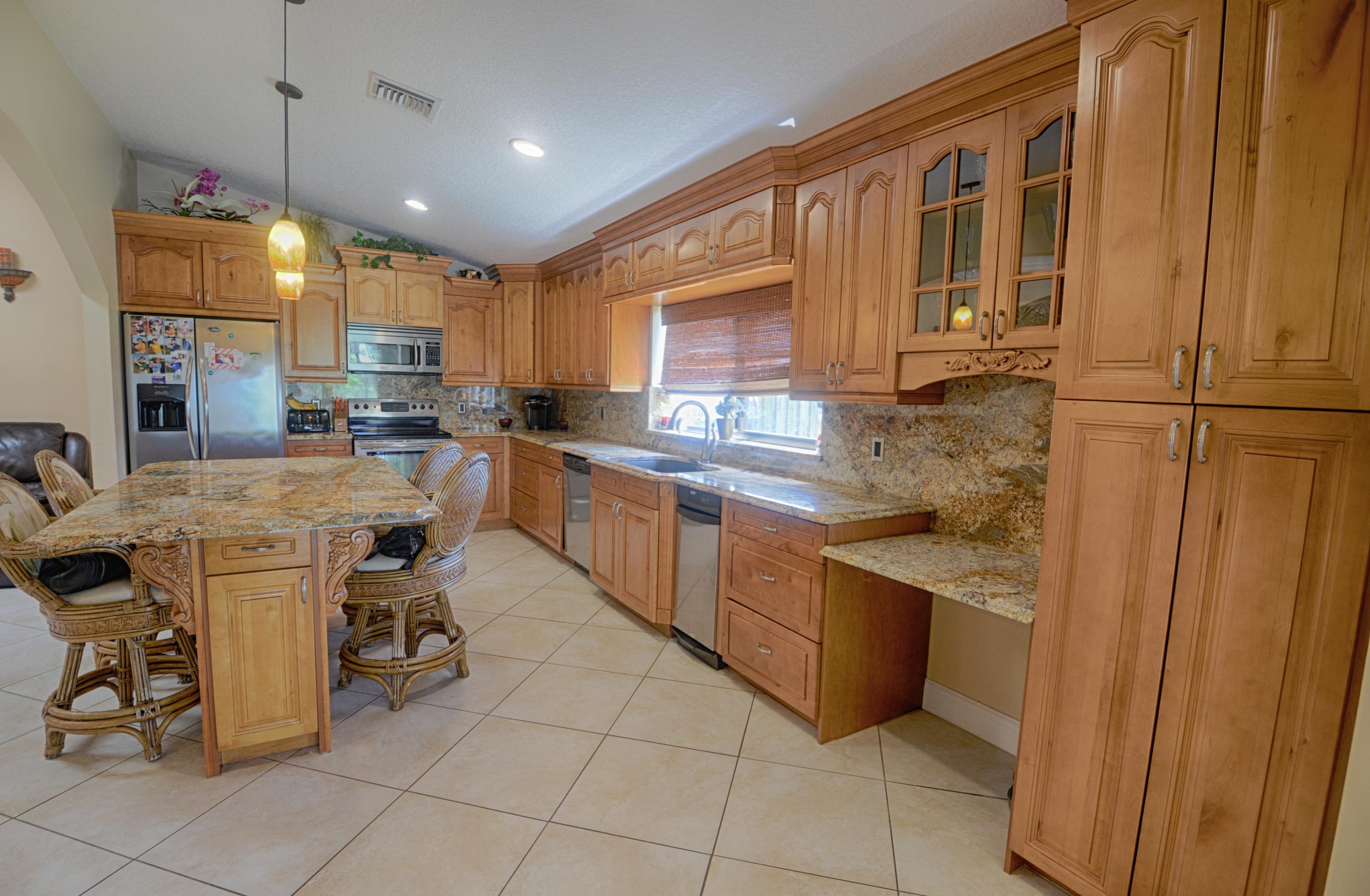 11885 Sunchase Court Boca Raton, FL 33498 - Photo 6 of 25 a kitchen with sink cabinets and window