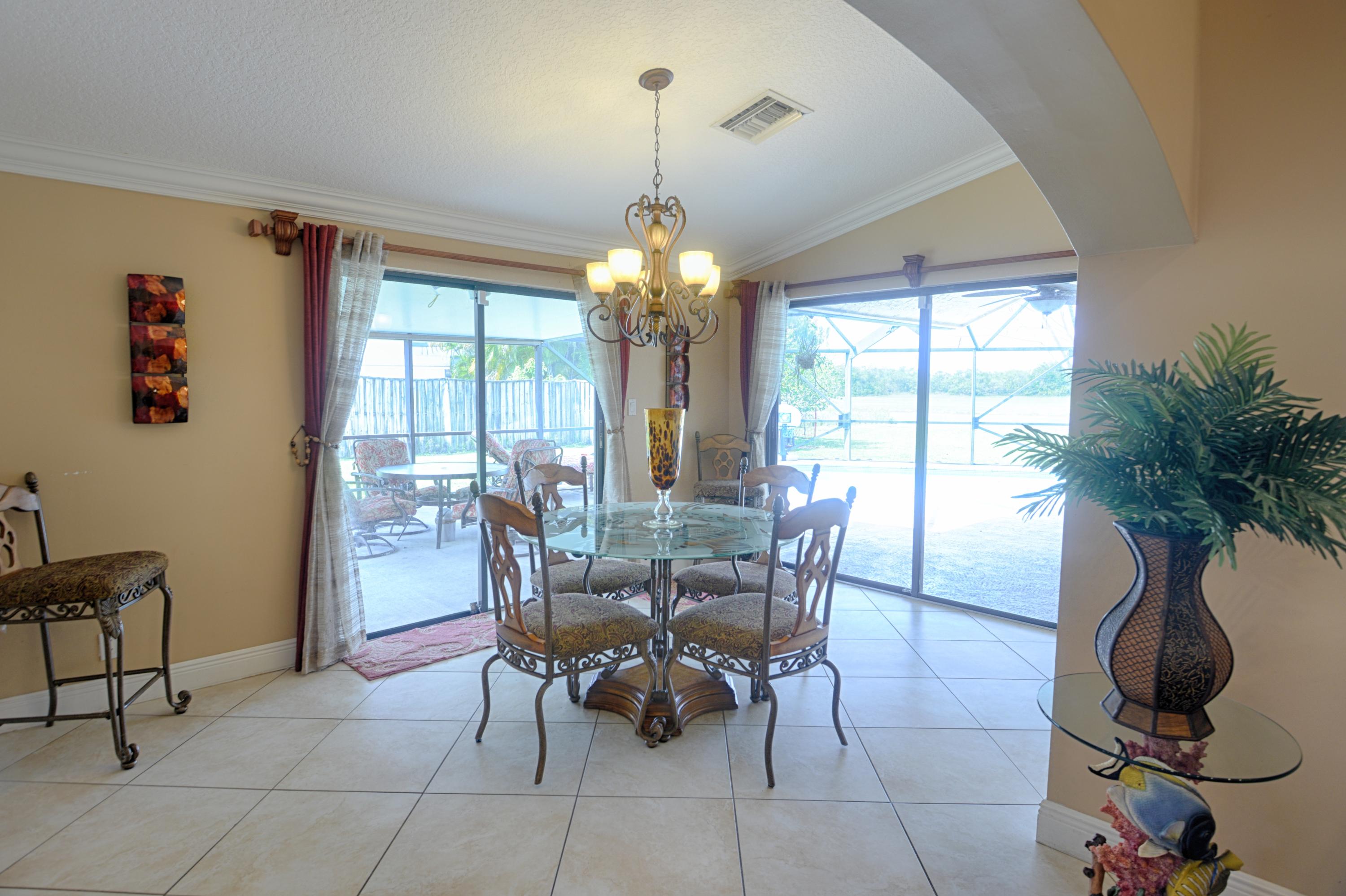11885 Sunchase Court Boca Raton, FL 33498 - Photo 8 of 25 a view of a dining room with furniture window and outside view
