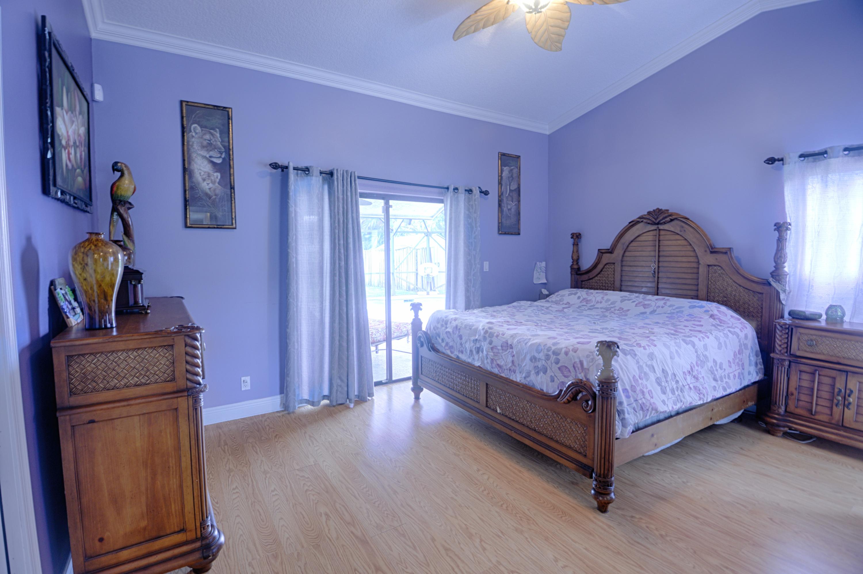 11885 Sunchase Court Boca Raton, FL 33498 - Photo 10 of 25 a bedroom with a bed lamps and dresser with wooden floor
