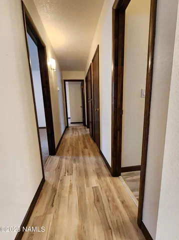 a view of empty room with wooden floor
