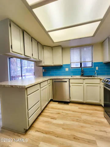 a kitchen with stainless steel appliances cabinets a sink and a counter top space