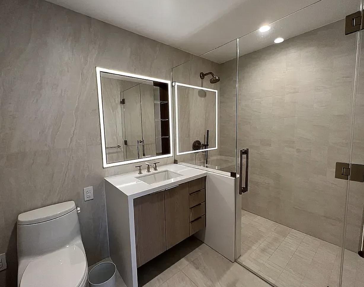 3 Court Square, Unit 4702 Queens, NY 11101 - Photo 3 of 5 a bathroom with a sink toilet and shower