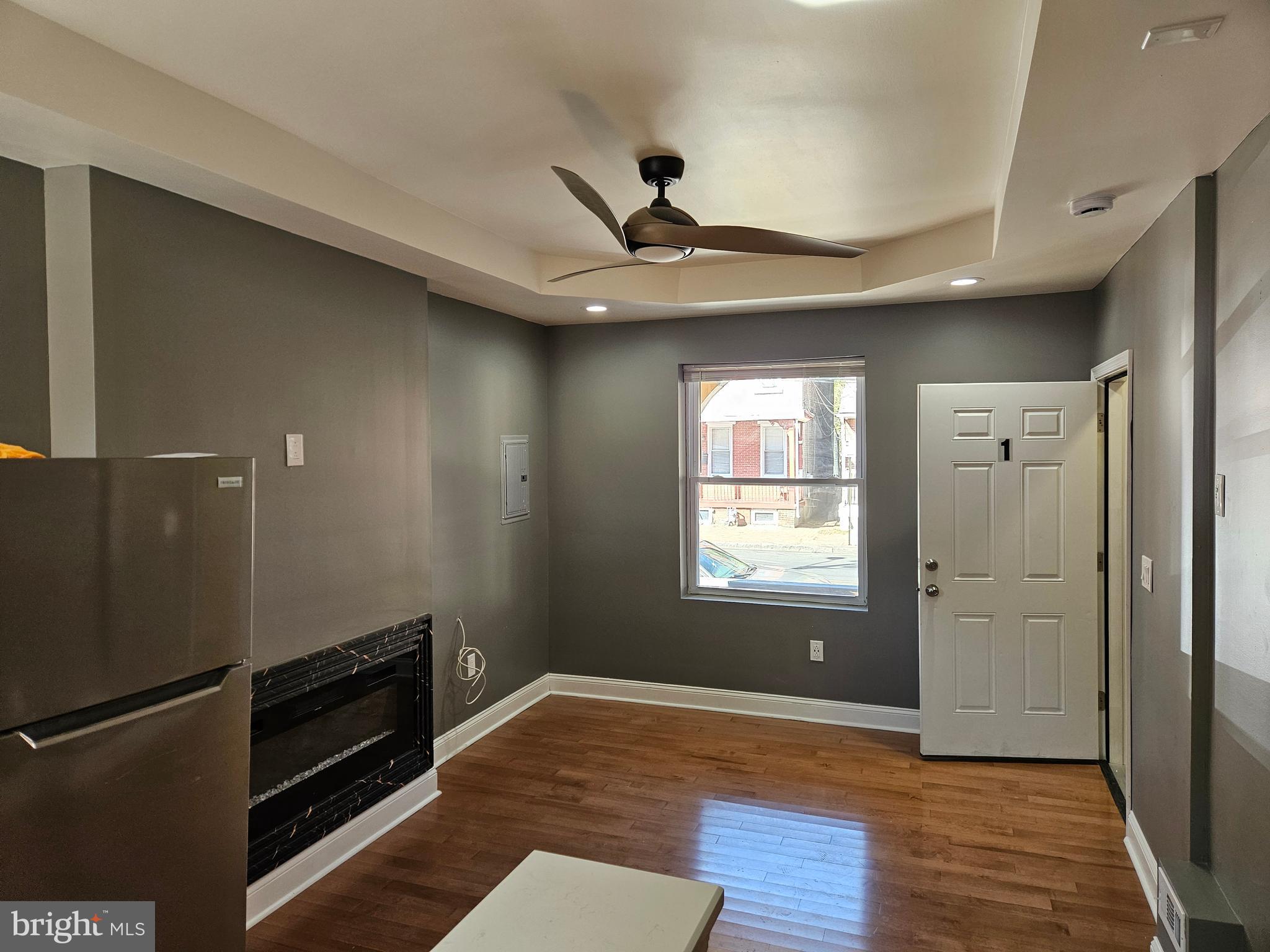 835 East State Street, Unit 1 Trenton, NJ 08609 - Photo 3 of 10 a view of an empty room with wooden floor and a window