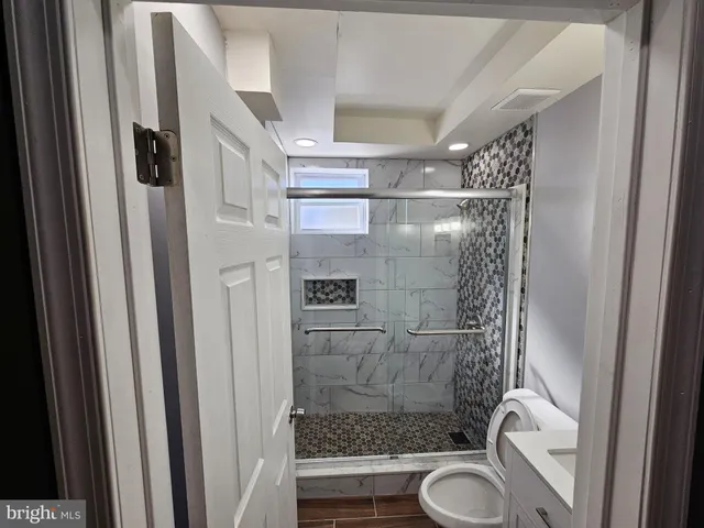 a bathroom with a shower a toilet and sink