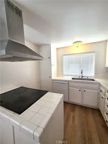 a kitchen with a sink a stove and cabinets
