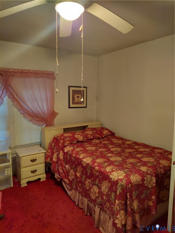 14511 Arwood Road Disputanta, VA 23842 - Photo 7 of 15 a bedroom with a bed and a chandelier