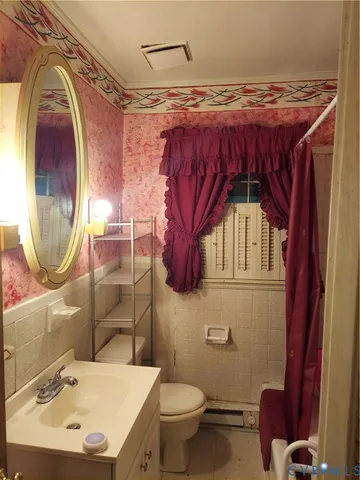 a bathroom with a sink a mirror and toilet