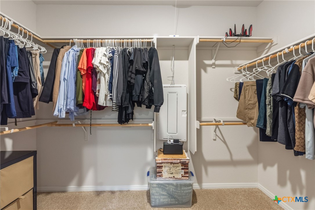 205 Charles Trail Georgetown, TX 78626 - Photo 25 of 38 a view of walk in closet with clothes and shoes