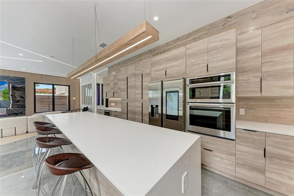 1716 9th Street Sarasota, FL 34236 - Photo 16 of 88 a kitchen with stainless steel appliances kitchen island a stove and a refrigerator