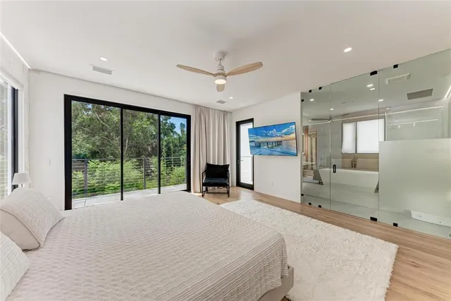 a spacious bedroom with a bed and a large window