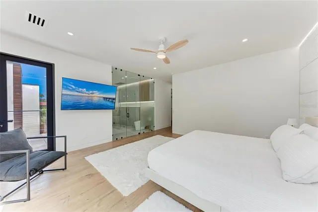 a bedroom with a bed and a ceiling fan