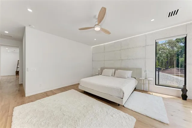 a bedroom with a large bed and a chandelier