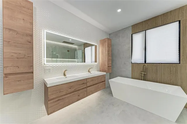 a bedroom with a large bed and a large window