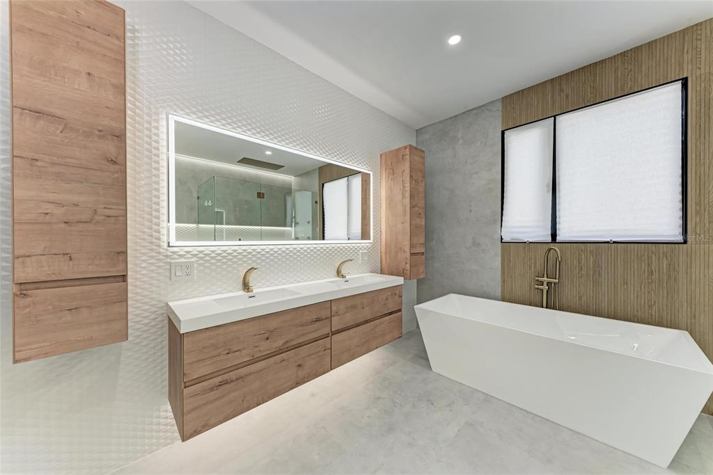 1716 9th Street Sarasota, FL 34236 - Photo 28 of 88 a bathroom with a tub a sink and a mirror