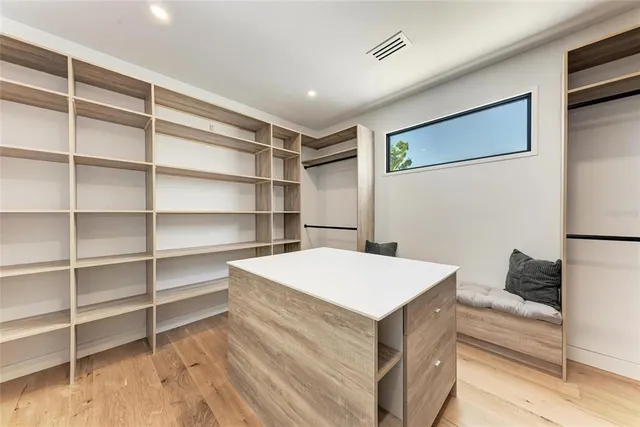 a bedroom with a bed and a ceiling fan