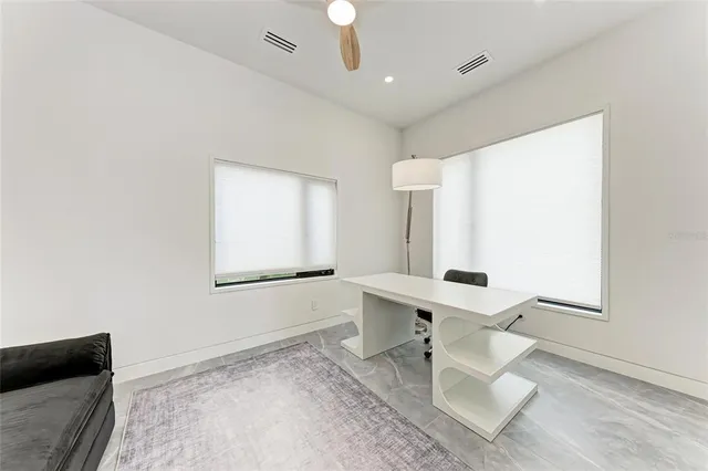 a bedroom with a large bed and a large window