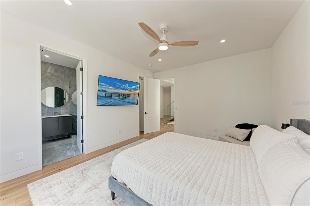 1716 9th Street Sarasota, FL 34236 - Photo 40 of 88 a bedroom with a large bed and a chandelier