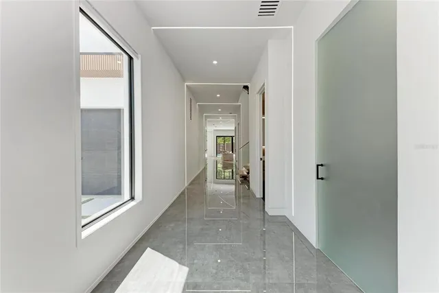 a view of an entryway with wooden floor and windows