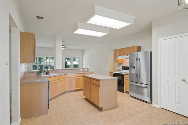 a kitchen with cabinets and stainless steel appliances
