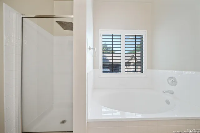 a bathroom with a bathtub and a shower