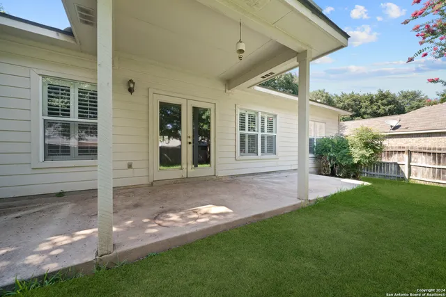 a view of a house with backyard and porch
