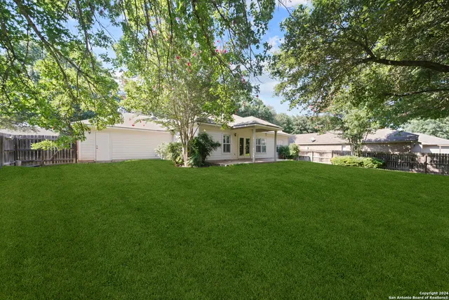 a view of house with backyard and garden