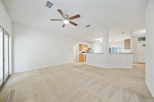 a view of a kitchen with a sink and a window