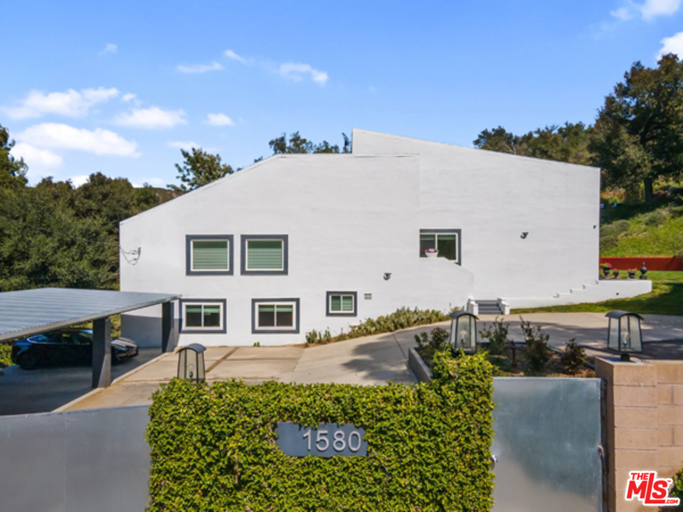 1580 Las Virgenes Road Calabasas, CA 91302 - Photo 2 of 51 a front view of a house with a lots of table and chairs