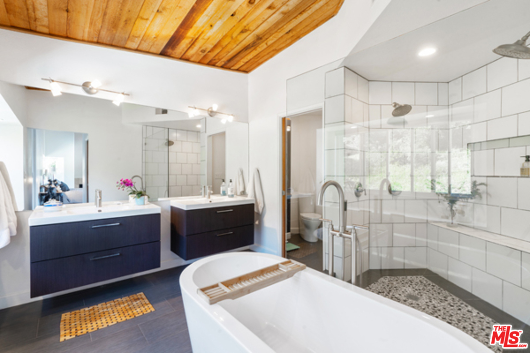 1580 Las Virgenes Road Calabasas, CA 91302 - Photo 21 of 51 a large bathroom with a tub sink and mirror