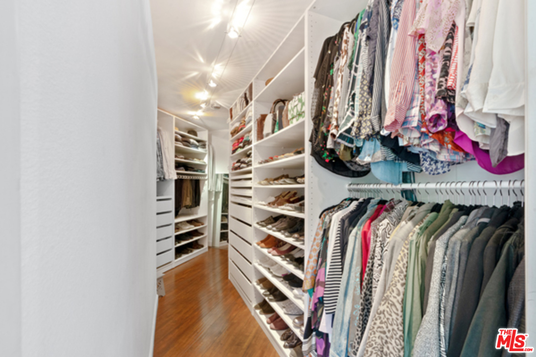 1580 Las Virgenes Road Calabasas, CA 91302 - Photo 22 of 51 a view of walk in closet with clothes and shoes