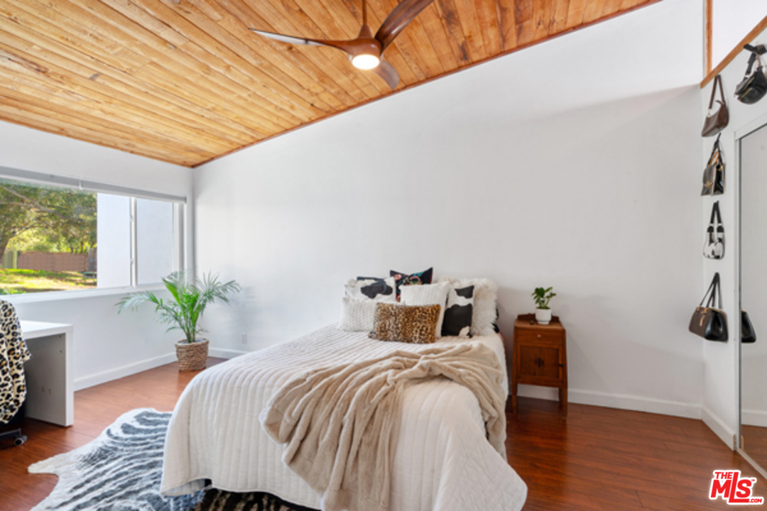 1580 Las Virgenes Road Calabasas, CA 91302 - Photo 28 of 51 a bed sitting in a spacious bedroom next to a window