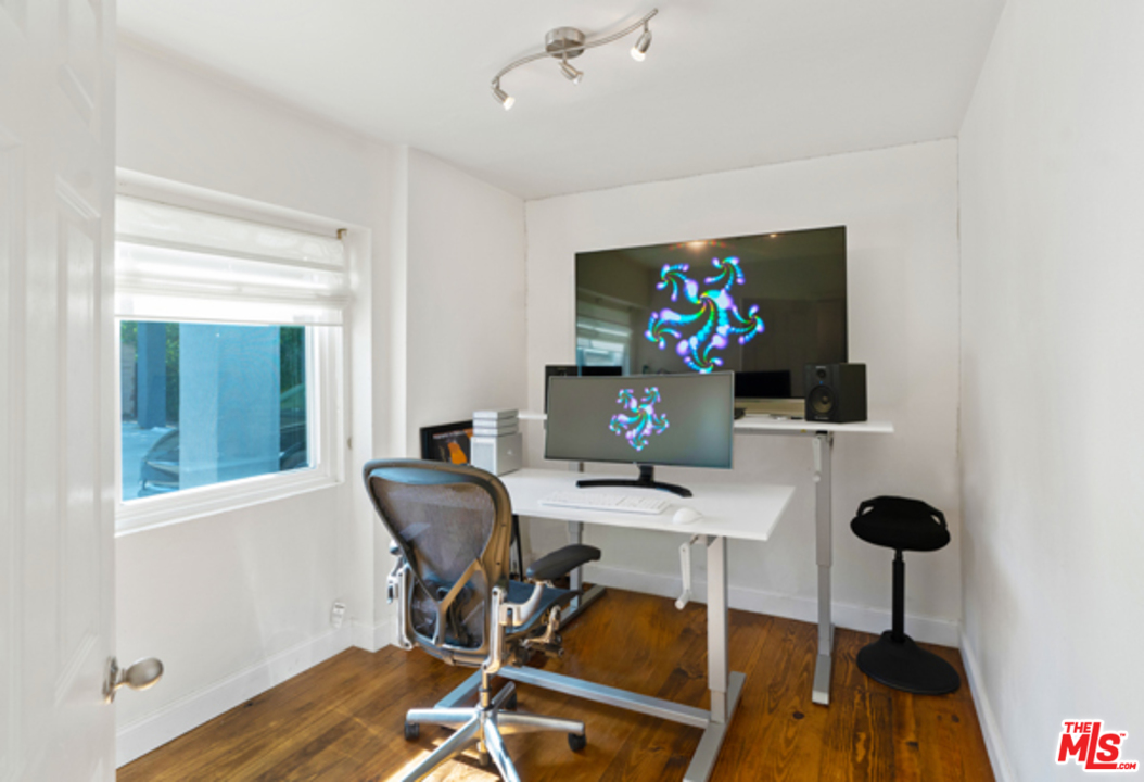 1580 Las Virgenes Road Calabasas, CA 91302 - Photo 35 of 51 a workspace with furniture and wooden floor