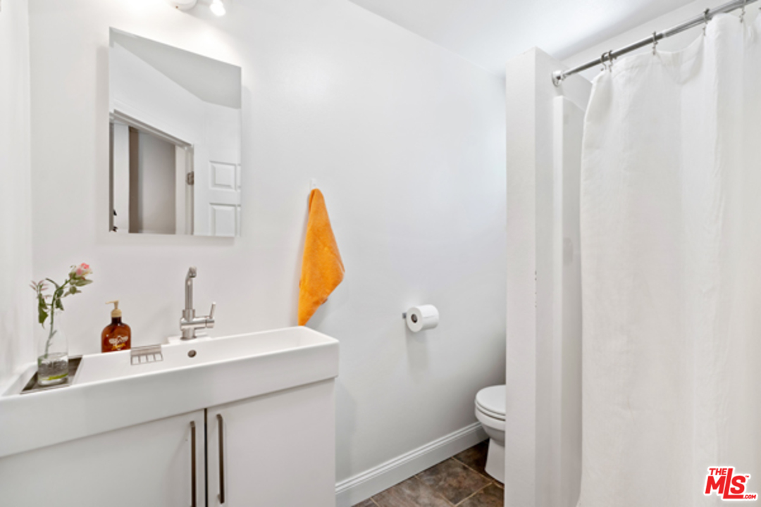 1580 Las Virgenes Road Calabasas, CA 91302 - Photo 36 of 51 a bathroom with a sink vanity mirror and toilet