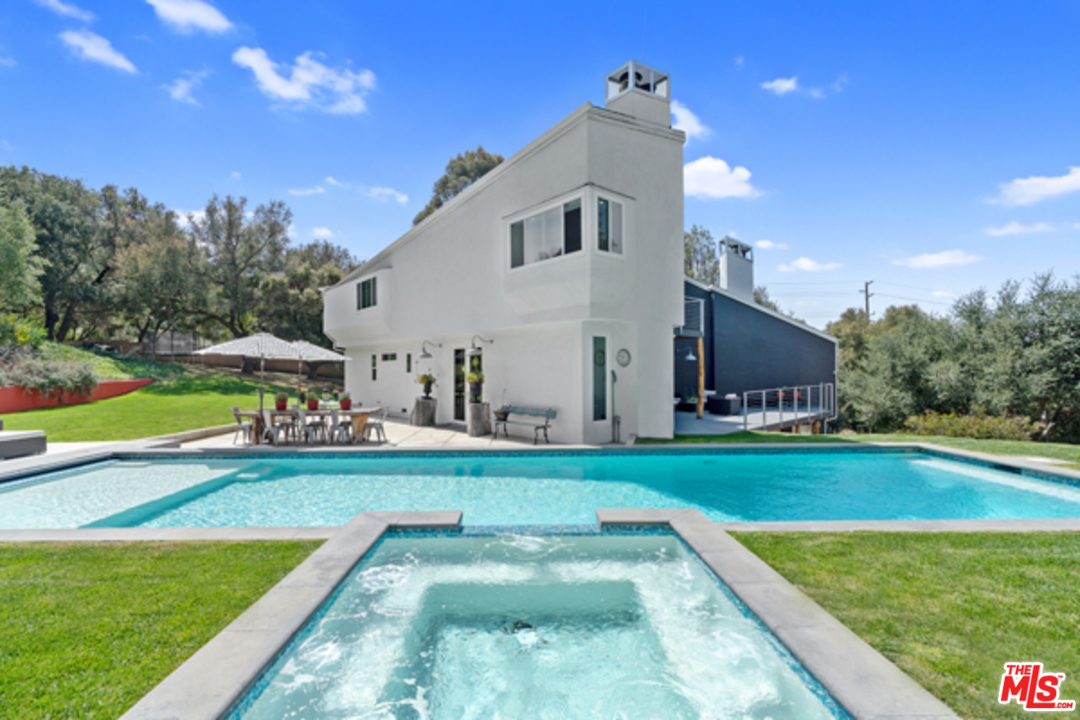 1580 Las Virgenes Road Calabasas, CA 91302 - Photo 39 of 51 a view of a house with a swimming pool and a yard