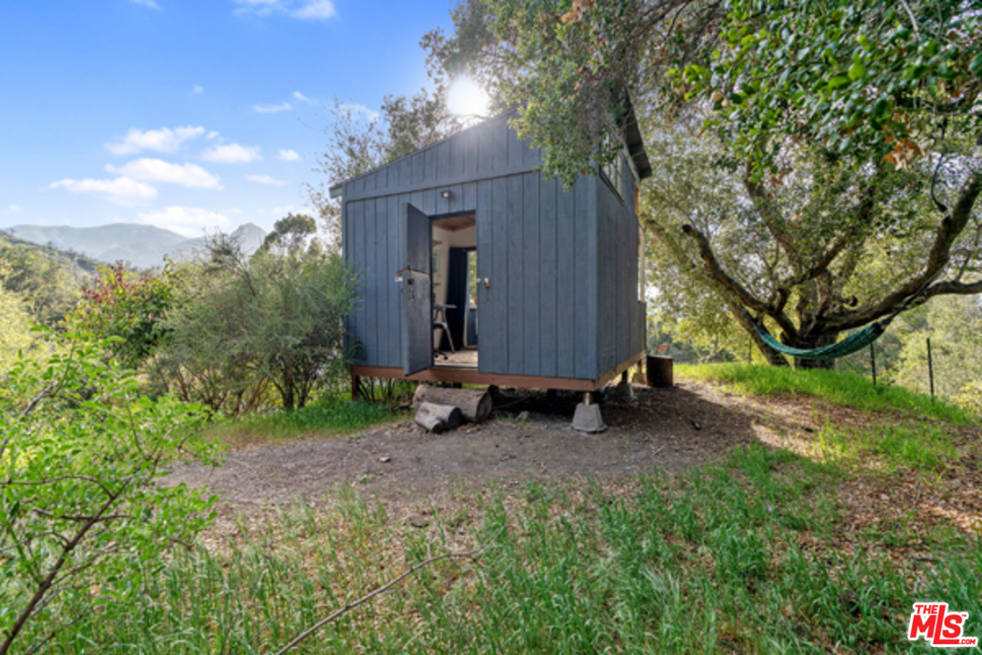 1580 Las Virgenes Road Calabasas, CA 91302 - Photo 49 of 51 a view of backyard with large trees and wooden fence