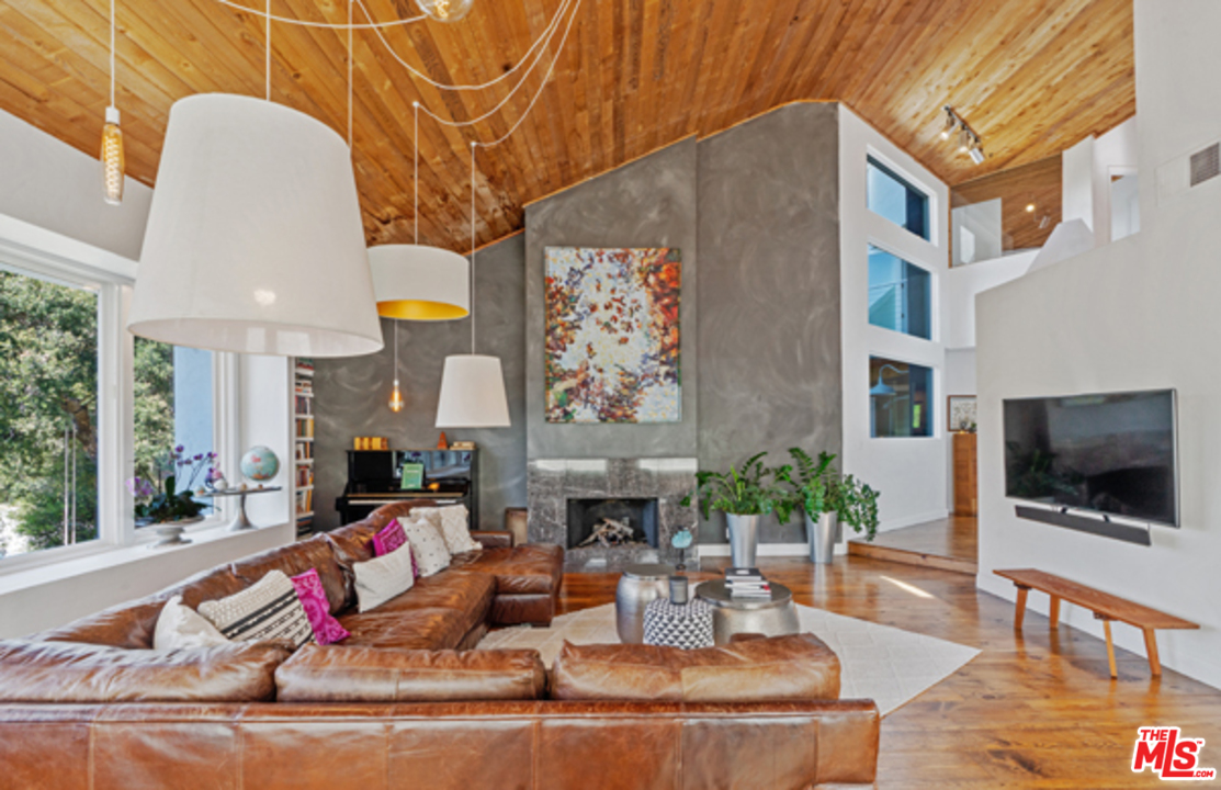 1580 Las Virgenes Road Calabasas, CA 91302 - Photo 6 of 51 a living room with fireplace furniture and a flat screen tv