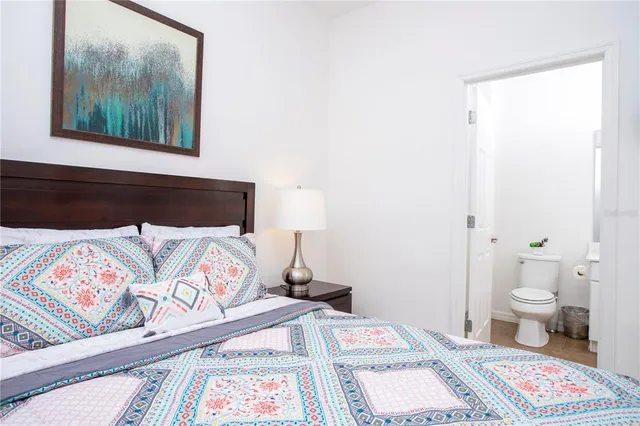 a bedroom with a bed and a rug