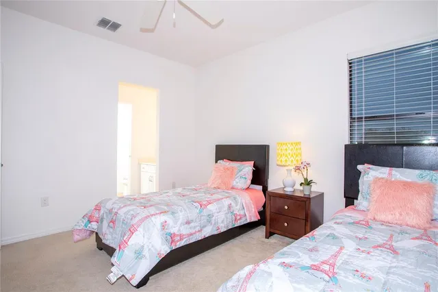 a bedroom with a bed and lamp