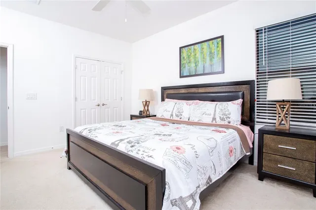 a bedroom with a bed and a night stand